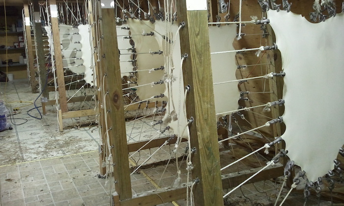 Parchment being stretched on a racks